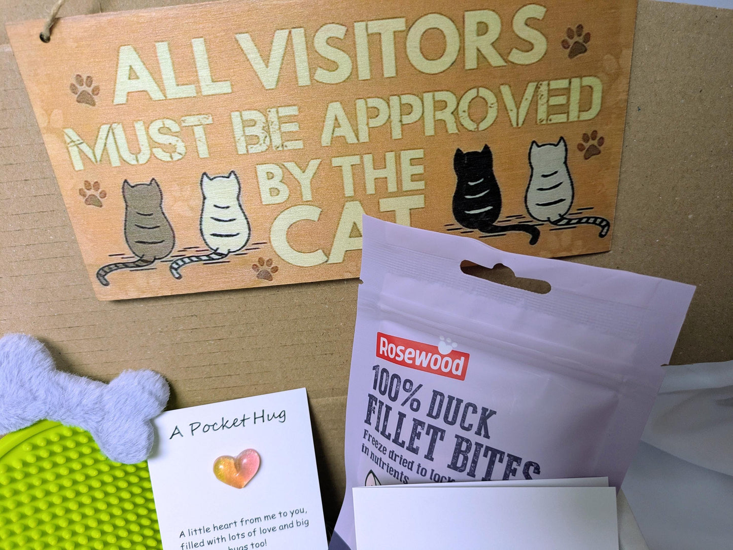 Personalised cat gift box with "All visitors must be approved by the cat" sign, duck fillet bites, and white bone-shaped cat .