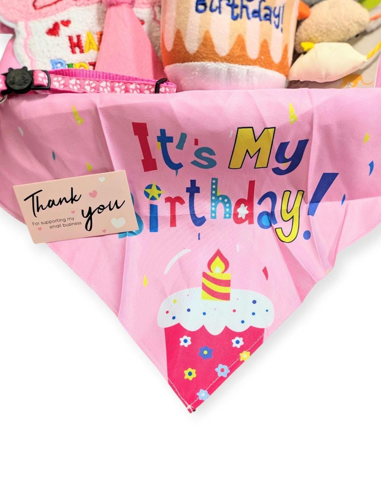 Pink cat bandana with colorful "It's My Birthday!" text and cupcake design, personalized gift tag attached.