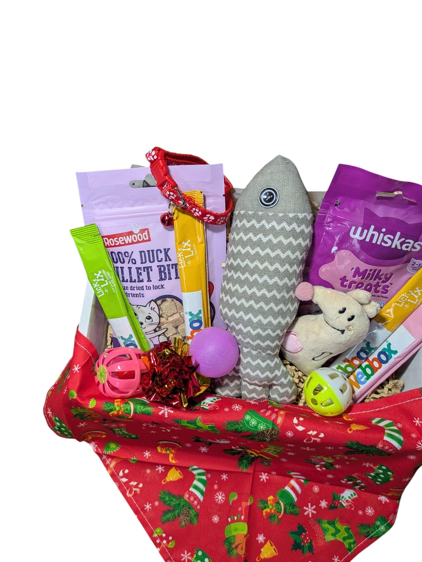 Festive red Christmas box filled with cat treats, toys, and a grey fish-shaped toy.