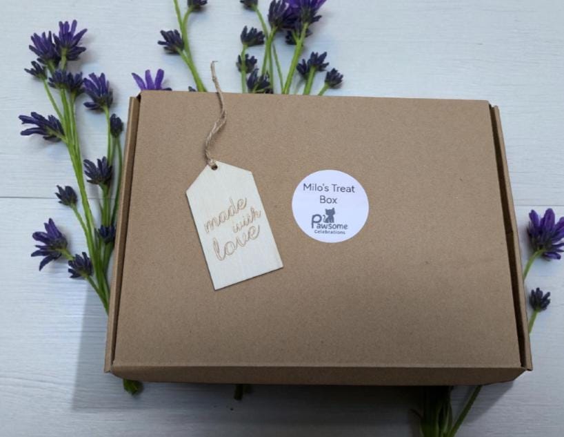 Brown eco-friendly gift box labeled Mini Treat Box with personalized tag, surrounded by lavender flowers.